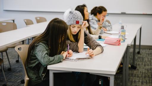 Students in class reading along while listening to lecture